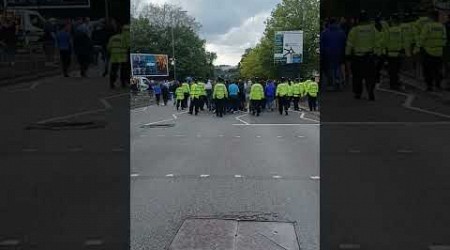 Millwall fans sheepishly leave St Andrews as they are shepherded by POLICE after game v Birmingham